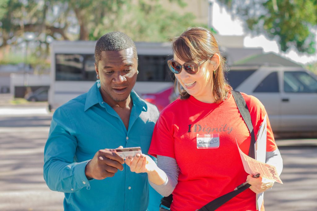 A client reacts to his new ID with wide eyes and amazement.
