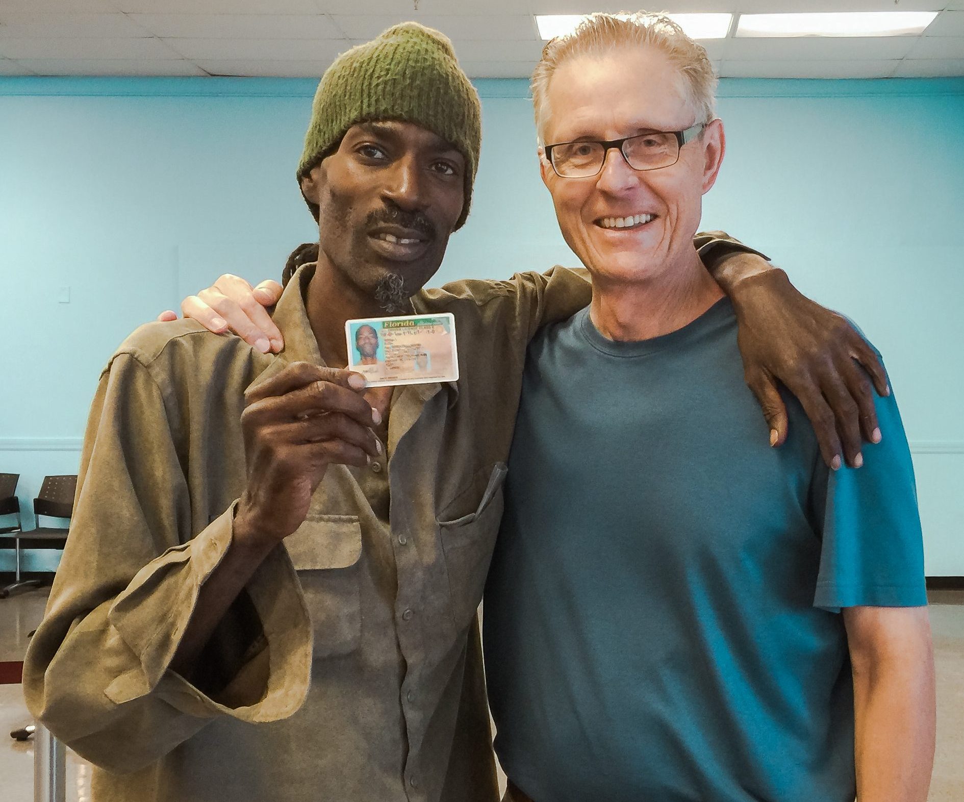 IDignity client Donell celebrates getting his new ID with IDignity Board Member Nick