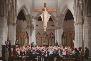 Over one hundred people stand together to honor each person who passed away in Central Florida after having experienced homelessness in 2019