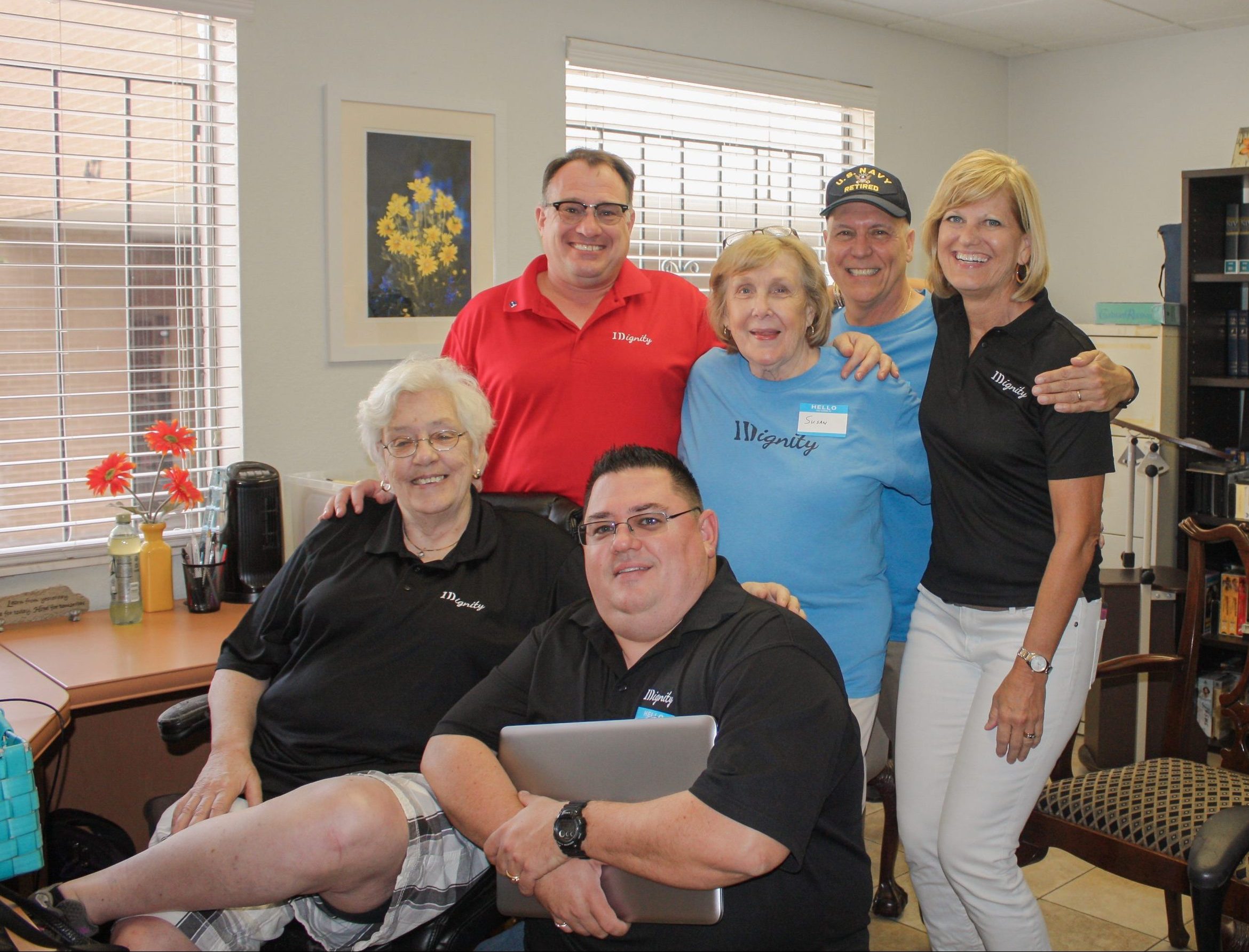 A group of volunteers and staff celebrate a great Client Care Day