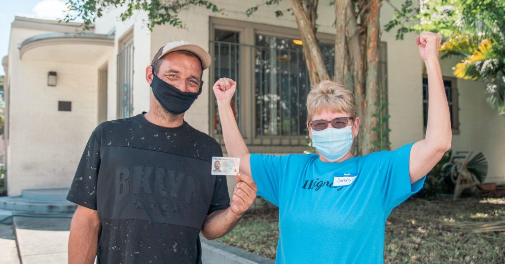 IDignity Client Cory celebrates getting his replacement ID with the volunteer that helped him.