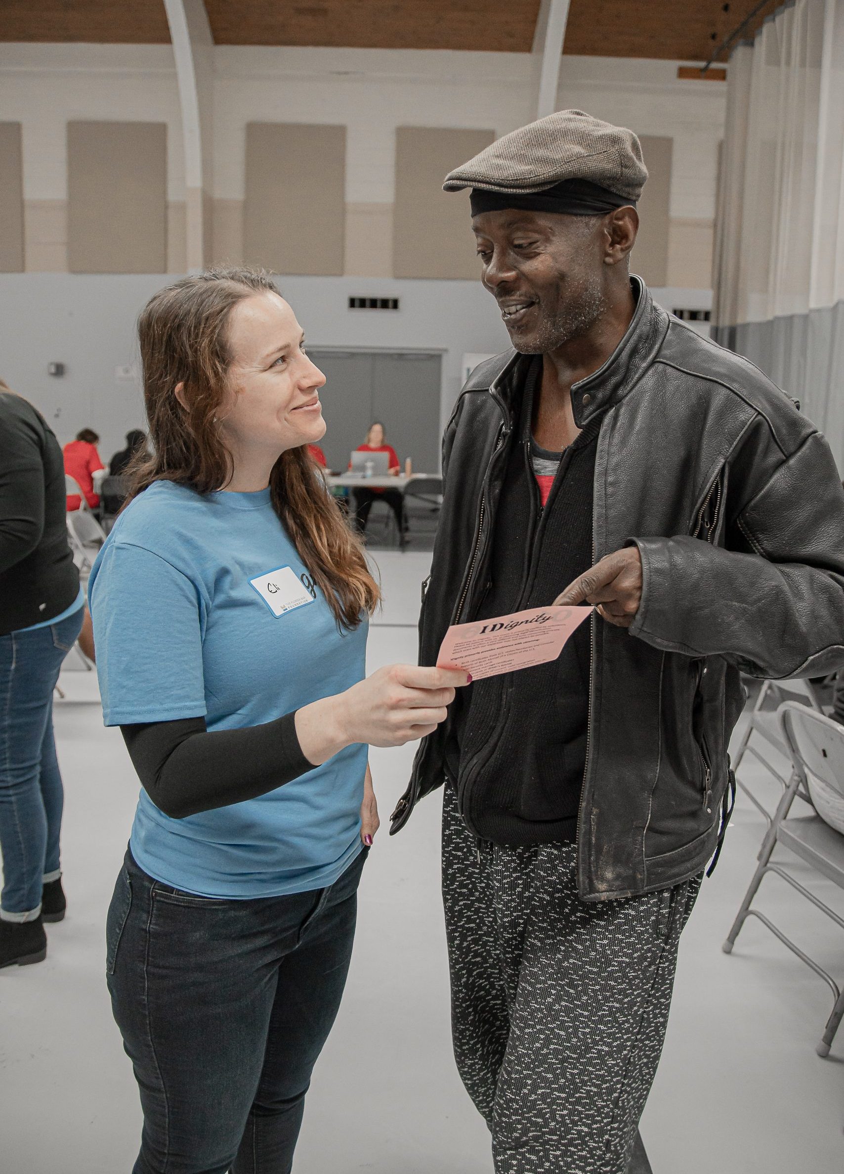A volunteer greets a client with a friendly smile